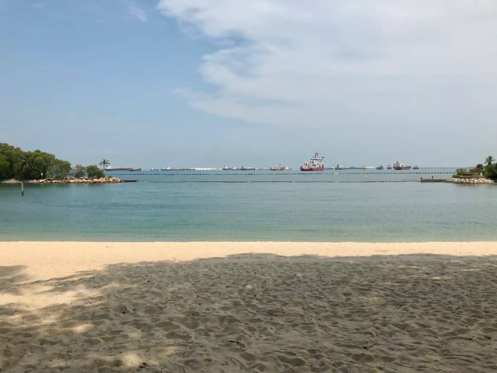 Singapore's Sentosa island beach with freight ships