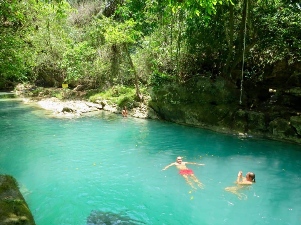 Swimming in the turquoise clear water at Green Valley, the perfect day trip from Pangandaran