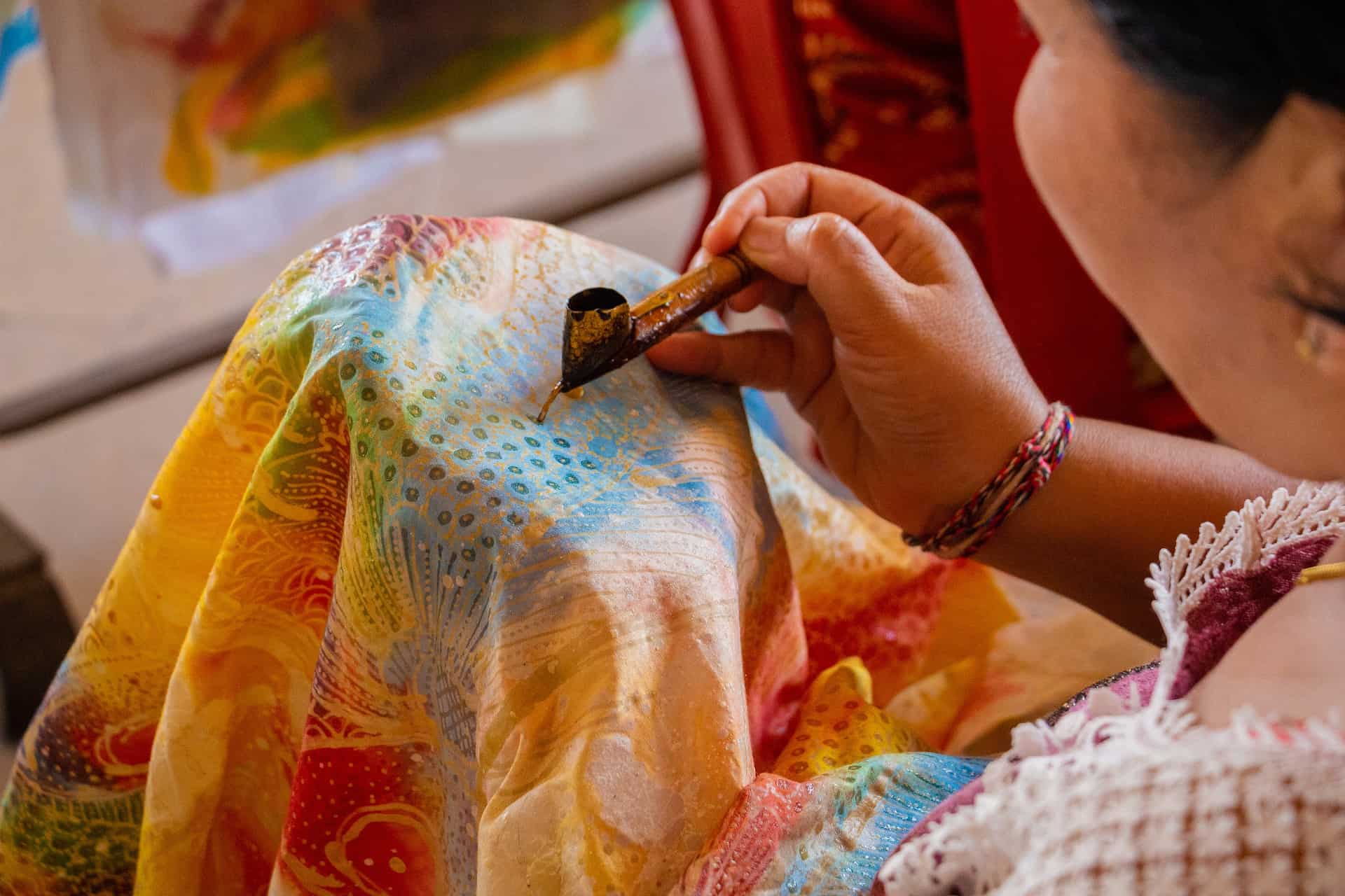 woman making batik art