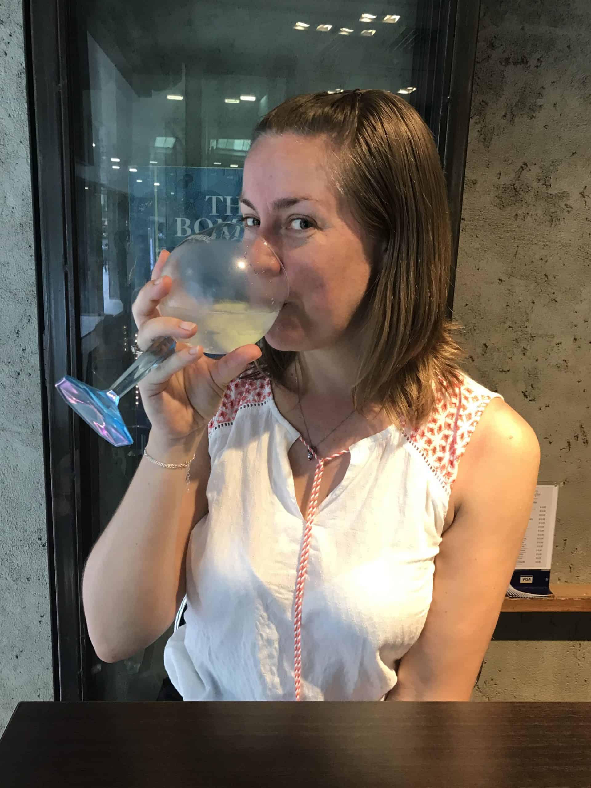 Joannda enjoying a G&T in Singapore although alcohol will bring your Singapore travel cost up quite significantly