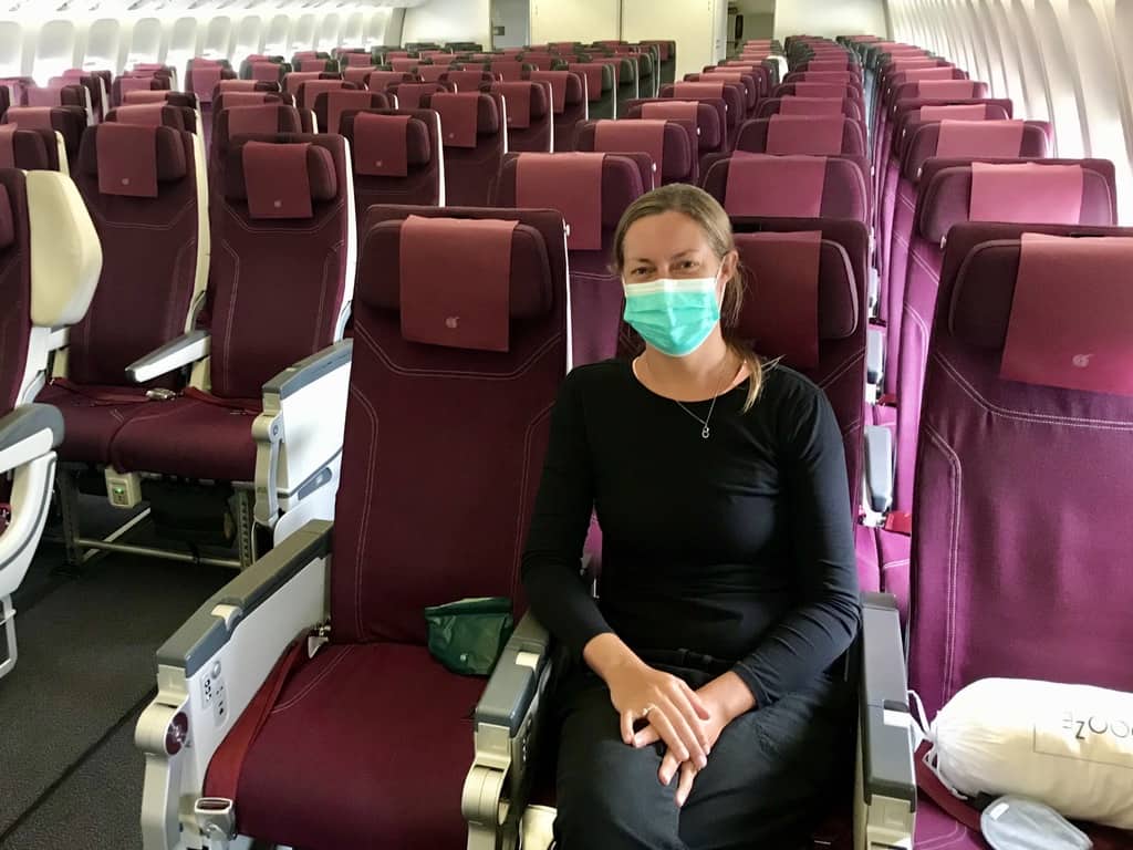 Joannda on the plane during the pandemic wearing a facemask