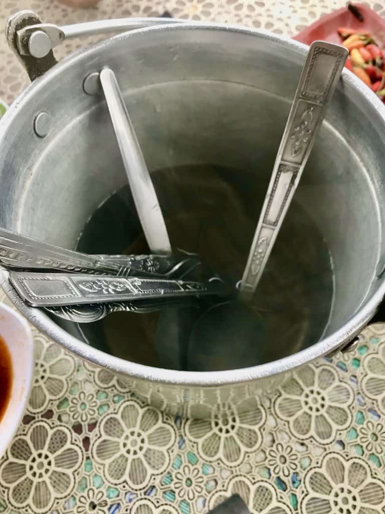 Cutlery in a pot of boiling water provided at a roadside stall