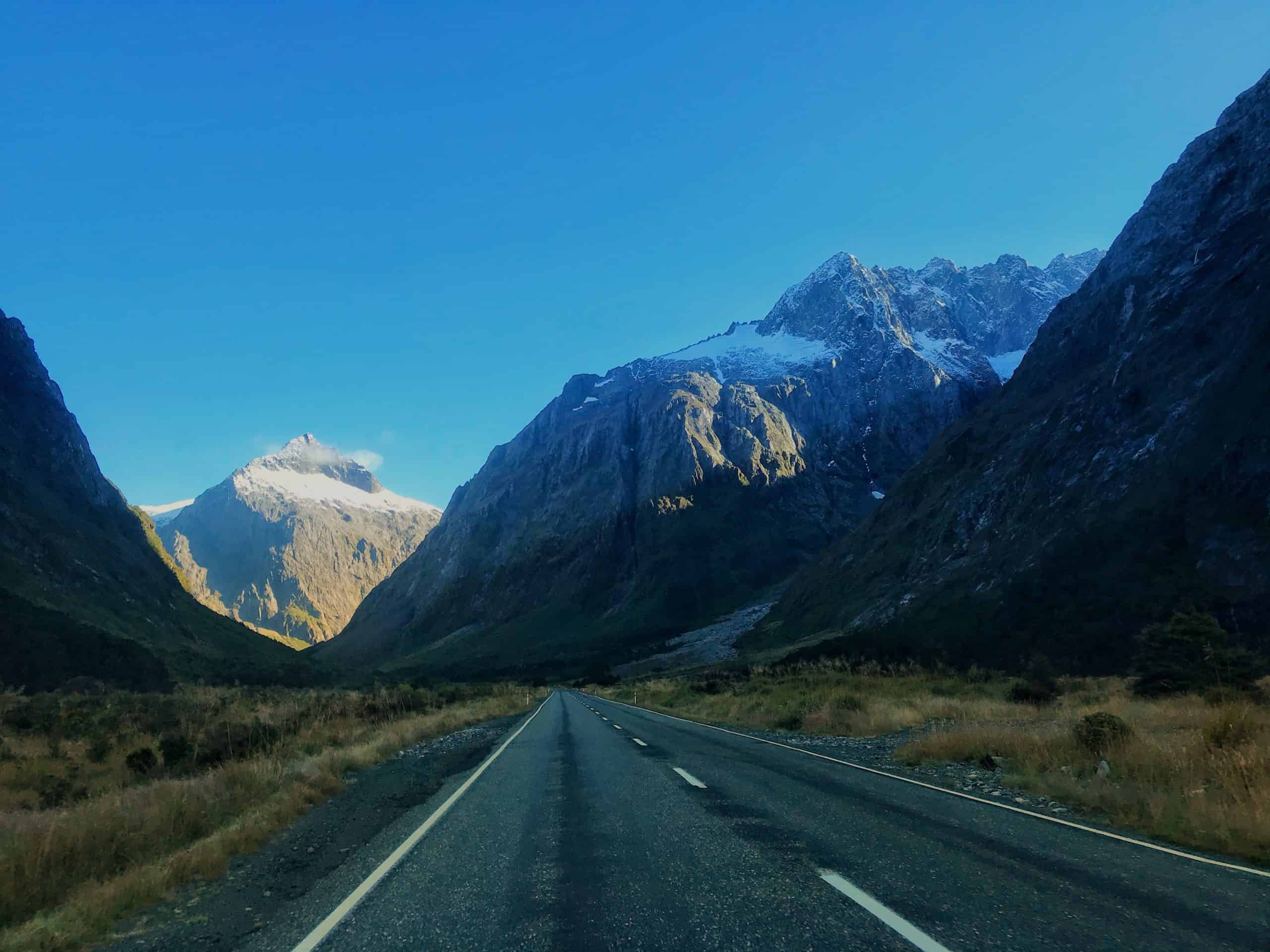 Watching the sun rise over the mountains on the drive to Milford Sound in Fiordland National Park